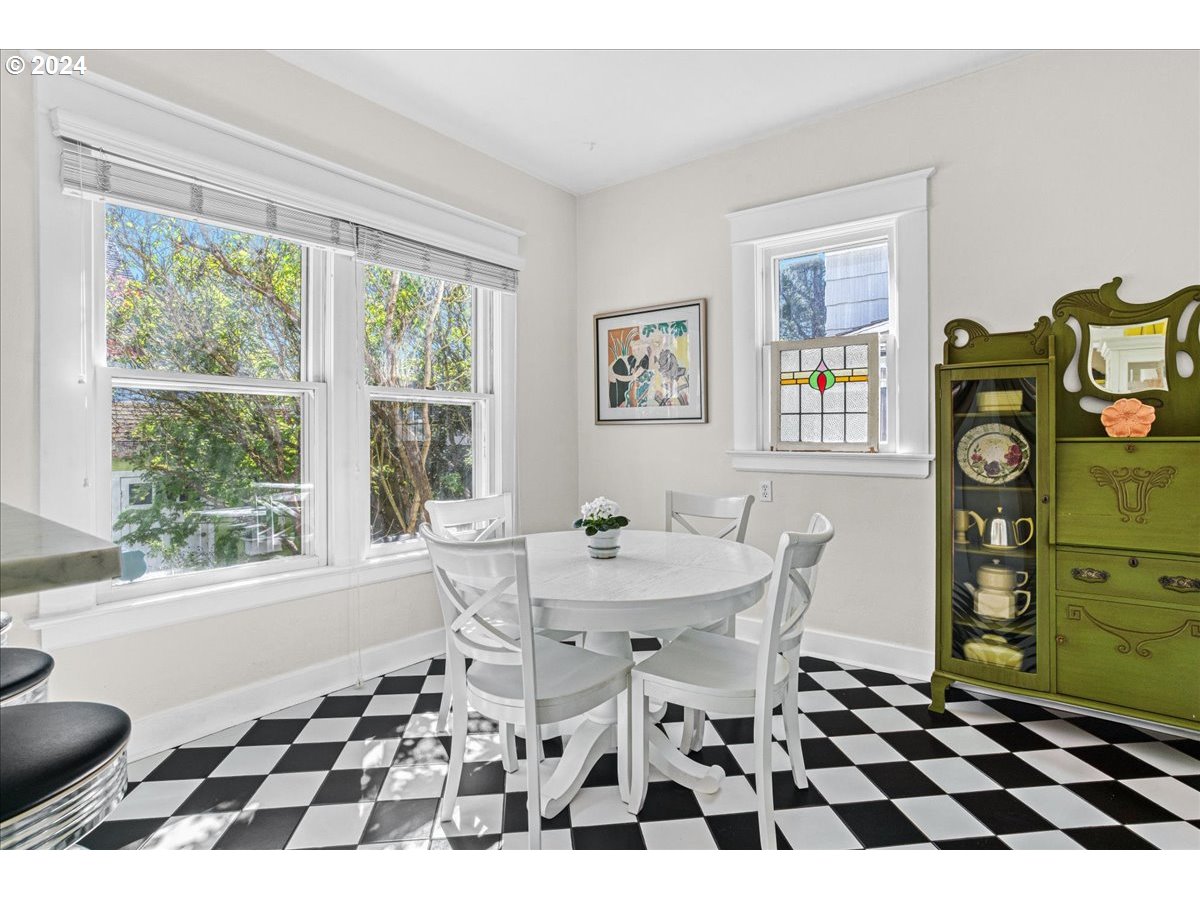 3752 Southeast Alder Street Portland, OR 97214 - Photo 16 of 44 a black and white checkered floor with a rug and a window