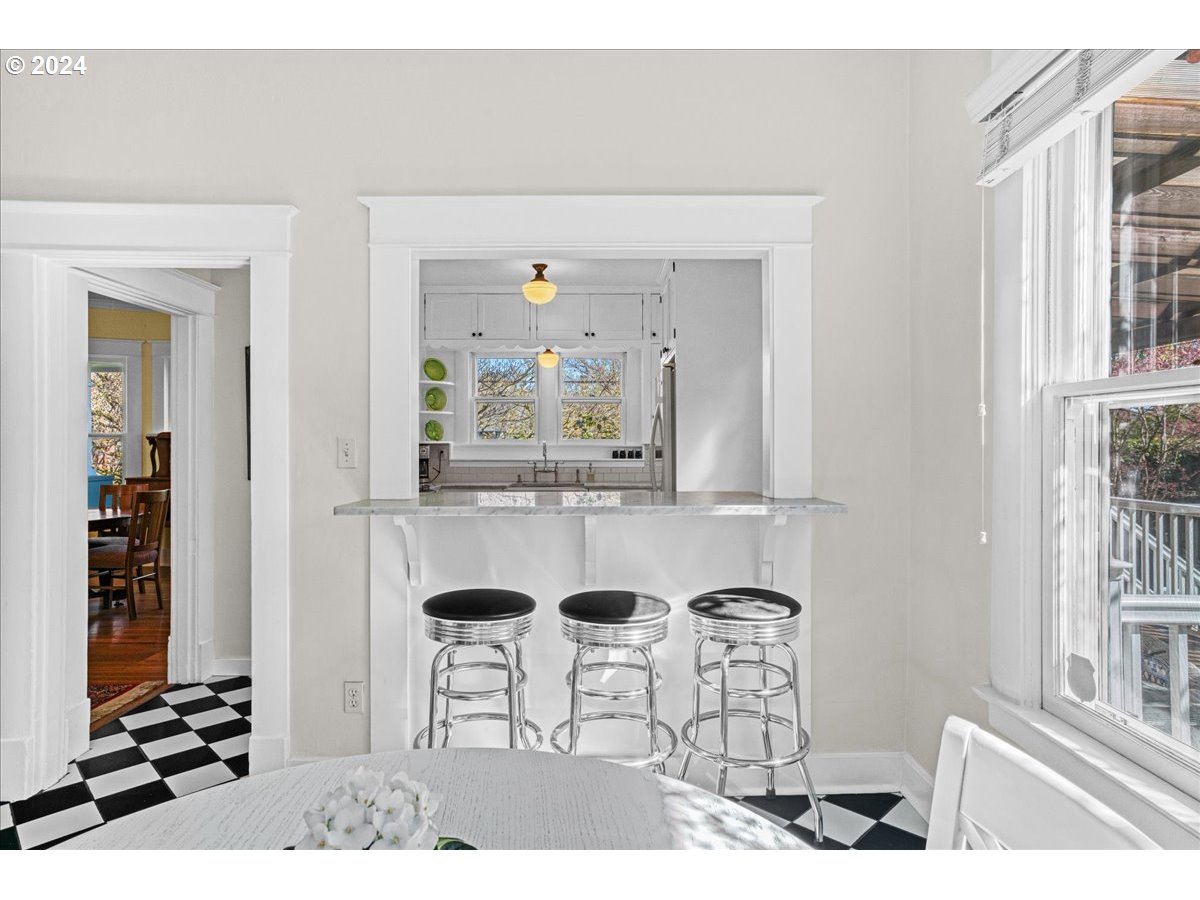 3752 Southeast Alder Street Portland, OR 97214 - Photo 17 of 44 a dining room with two couches and a dining table with wooden floor