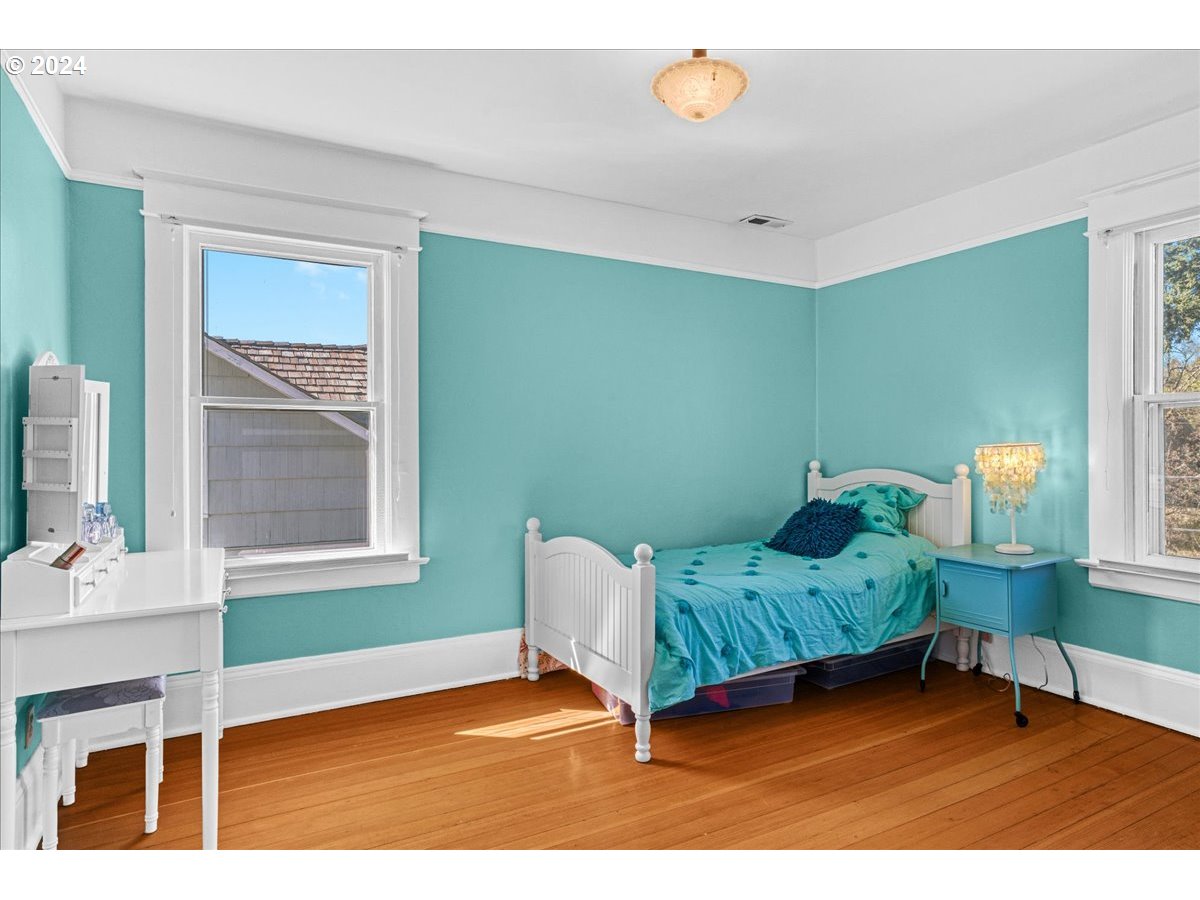 3752 Southeast Alder Street Portland, OR 97214 - Photo 19 of 44 a bedroom with furniture and a window