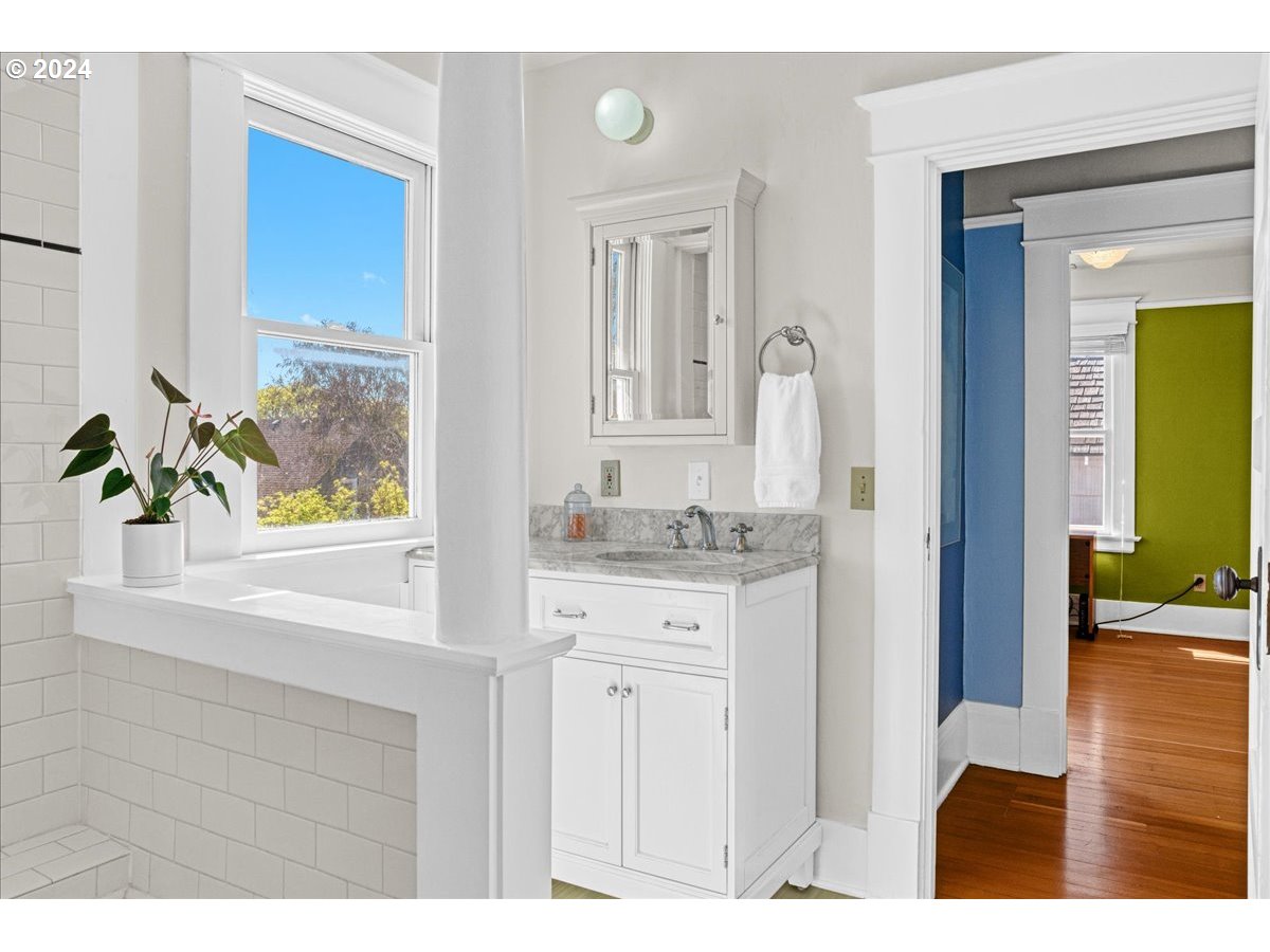 3752 Southeast Alder Street Portland, OR 97214 - Photo 25 of 44 a bathroom with a sink a vanity and a mirror