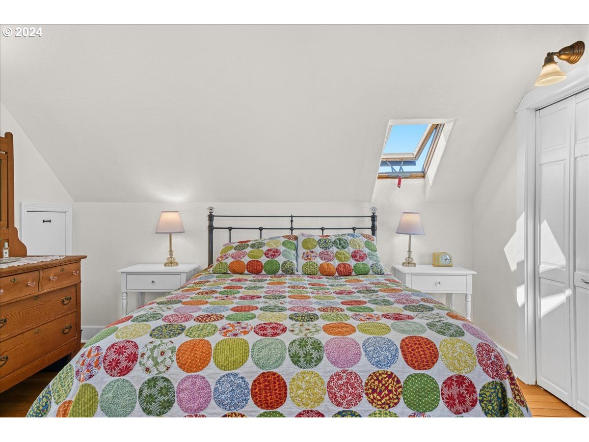 3752 Southeast Alder Street Portland, OR 97214 - Photo 28 of 44 a bedroom with a bed and a lamp on dresser