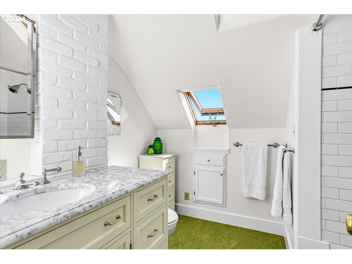 3752 Southeast Alder Street Portland, OR 97214 - Photo 32 of 44 a bathroom with a granite countertop sink and a mirror