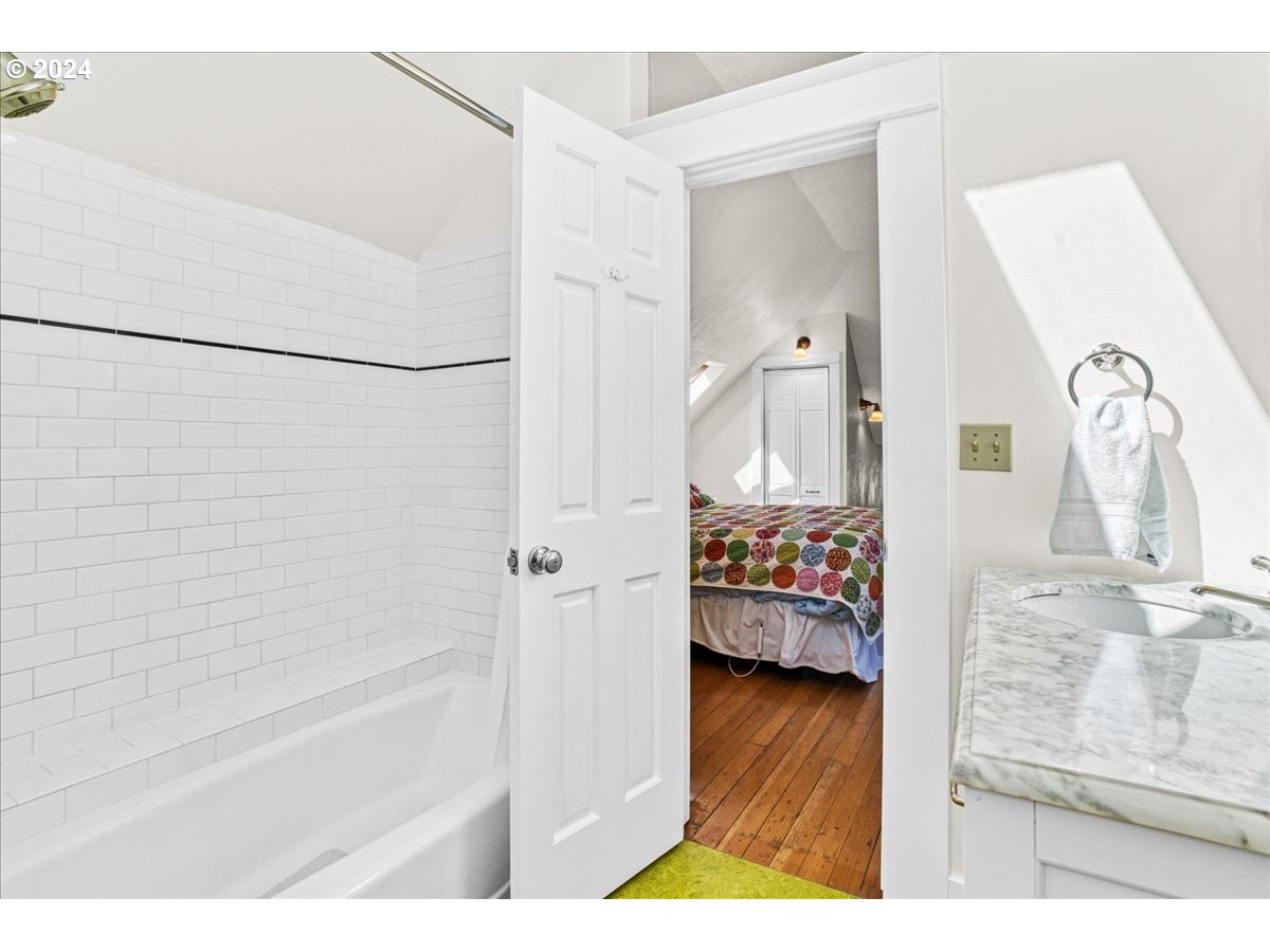 3752 Southeast Alder Street Portland, OR 97214 - Photo 33 of 44 a bathroom with a bathtub sink and mirror