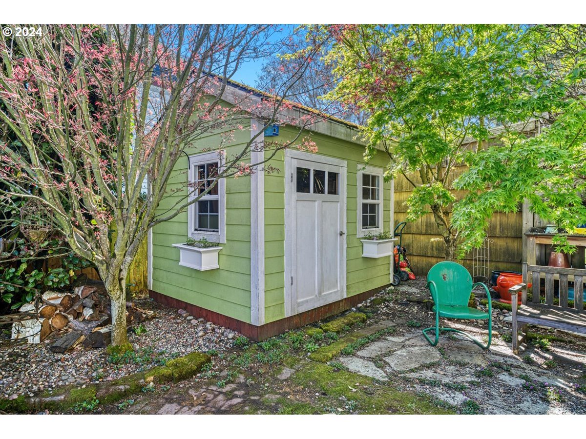 3752 Southeast Alder Street Portland, OR 97214 - Photo 36 of 44 a view of a small house in the middle of a backyard