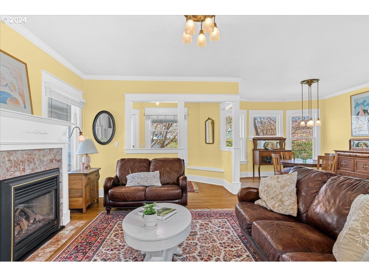 3752 Southeast Alder Street Portland, OR 97214 - Photo 7 of 44 a living room with furniture a fireplace and a large window
