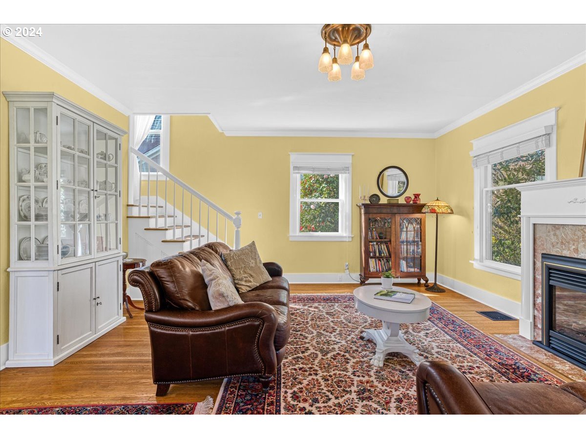 3752 Southeast Alder Street Portland, OR 97214 - Photo 8 of 44 a living room with furniture a fireplace and a large window