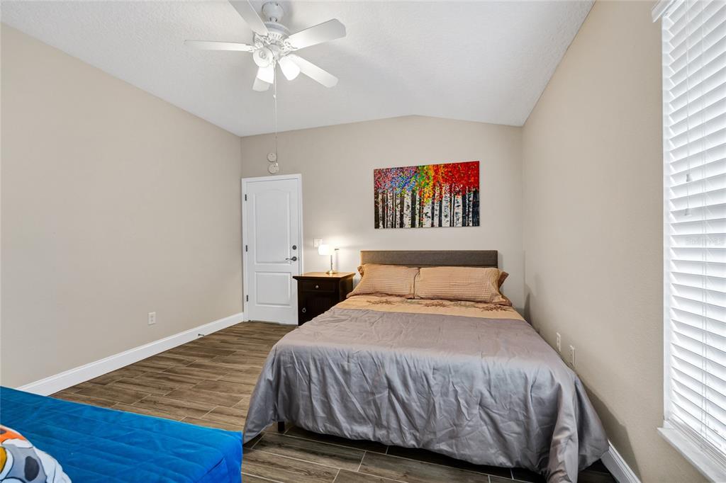 841 Grovesmere Loop Ocoee, FL 34761 - Photo 22 of 48 a bedroom with a bed and a chandelier