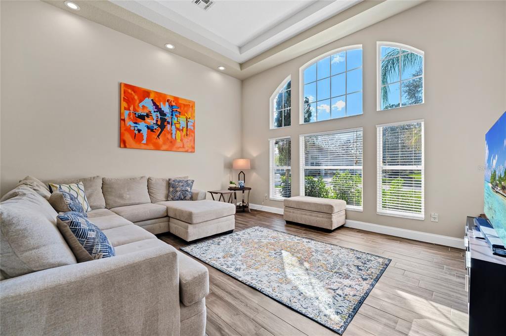 841 Grovesmere Loop Ocoee, FL 34761 - Photo 4 of 48 a living room with furniture and a large window