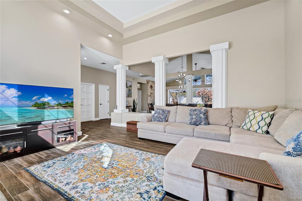 841 Grovesmere Loop Ocoee, FL 34761 - Photo 5 of 48 a living room with furniture and a flat screen tv