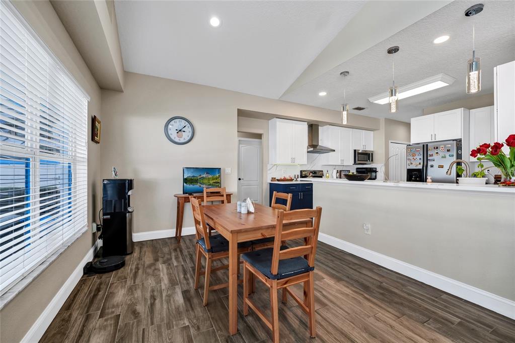841 Grovesmere Loop Ocoee, FL 34761 - Photo 10 of 48 a view of a dining room with furniture window and wooden floor