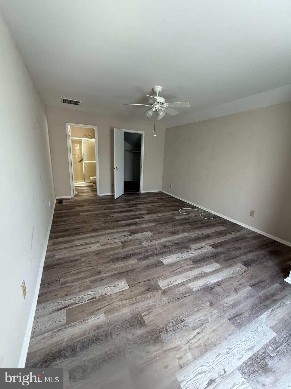 5702B Adelaide Drive Mount Laurel, NJ 08054 - Photo 17 of 22 a view of an empty room with wooden floor and a window