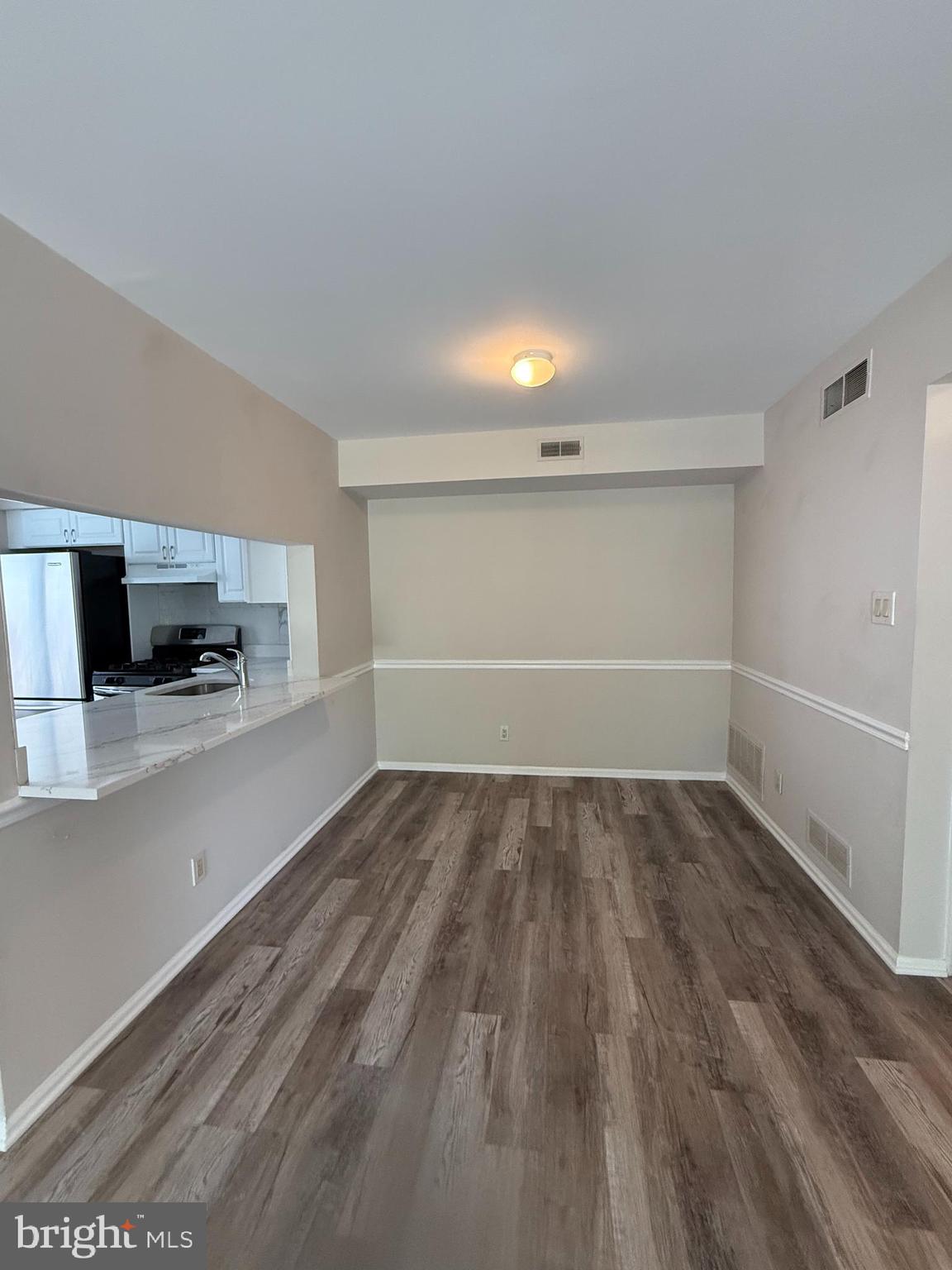 5702B Adelaide Drive Mount Laurel, NJ 08054 - Photo 6 of 22 a view of empty room with wooden floor and electronic appliances