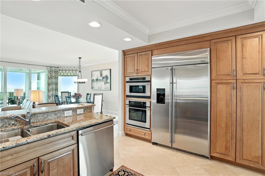 265 Indies Way, Unit 1605 Naples, FL 34110 - Photo 12 of 49 a kitchen with a refrigerator and a sink