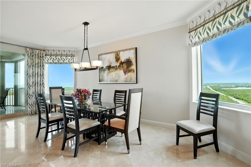 265 Indies Way, Unit 1605 Naples, FL 34110 - Photo 15 of 49 a view of a dining room with furniture window and wooden floor