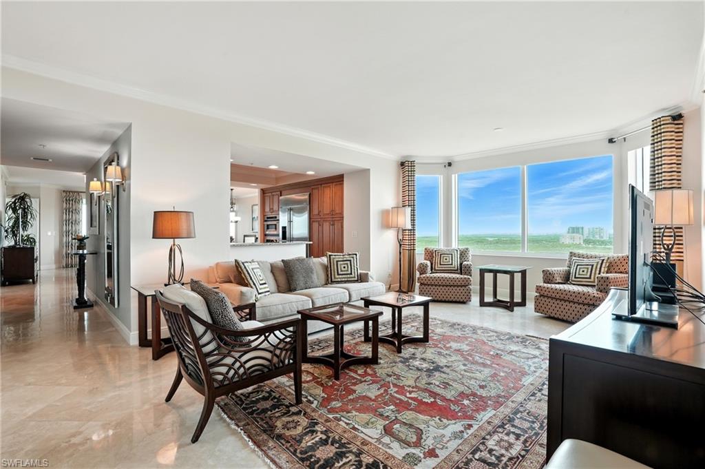 265 Indies Way, Unit 1605 Naples, FL 34110 - Photo 18 of 49 a living room with furniture large windows and wooden floor
