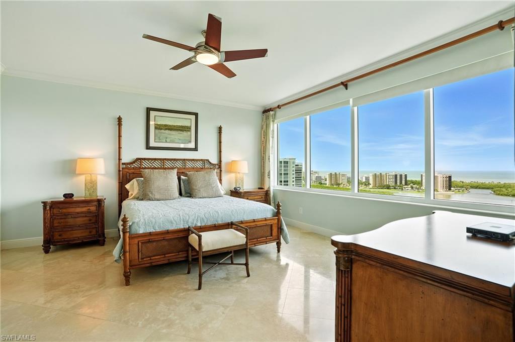 265 Indies Way, Unit 1605 Naples, FL 34110 - Photo 19 of 49 a bedroom with a bed and a view of kitchen
