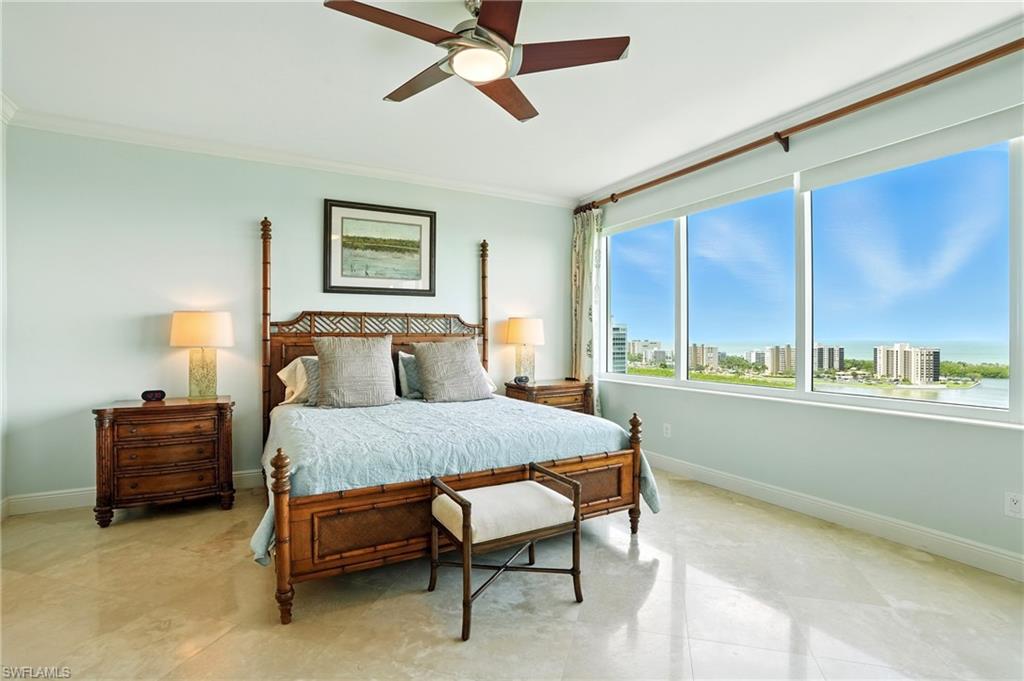265 Indies Way, Unit 1605 Naples, FL 34110 - Photo 20 of 49 a bedroom with a bed and a table