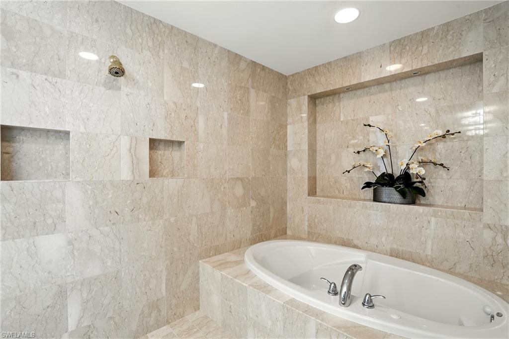 265 Indies Way, Unit 1605 Naples, FL 34110 - Photo 24 of 49 a bathroom with a bathtub and shower