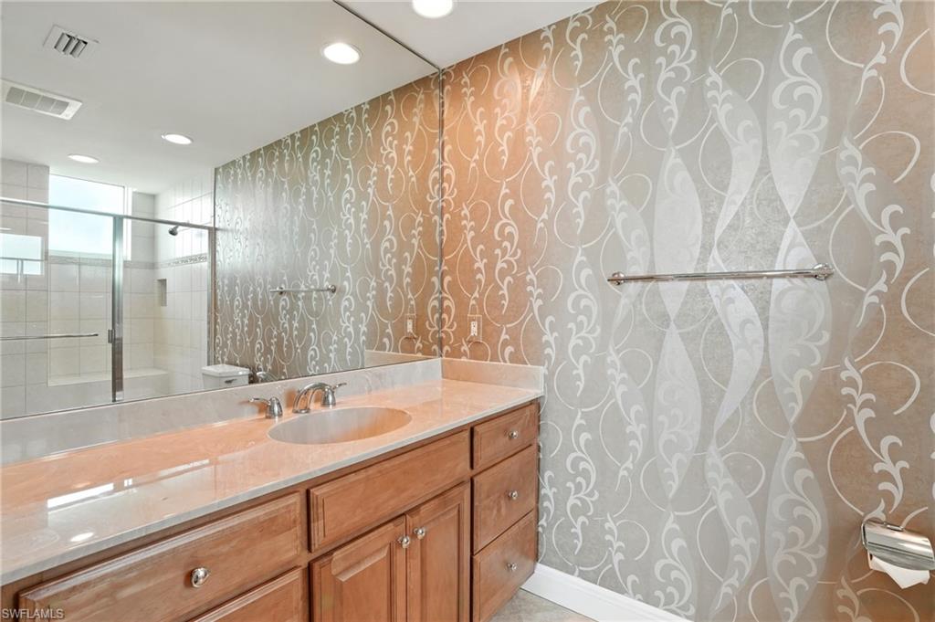 265 Indies Way, Unit 1605 Naples, FL 34110 - Photo 27 of 49 a bathroom with a sink and a mirror
