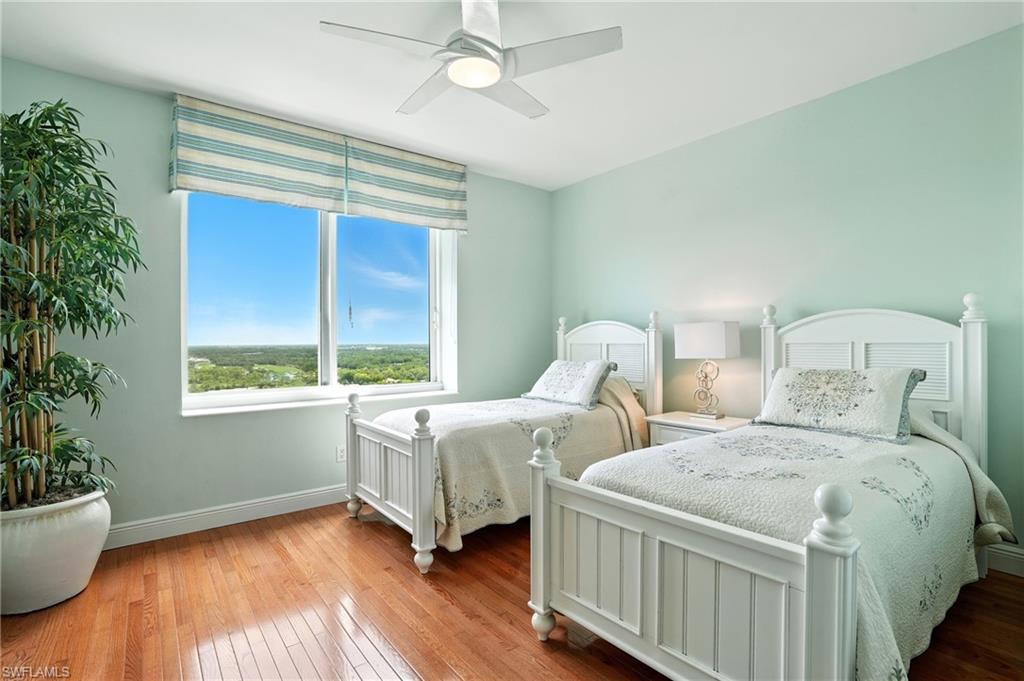265 Indies Way, Unit 1605 Naples, FL 34110 - Photo 29 of 49 a bedroom with two beds and a potted plant