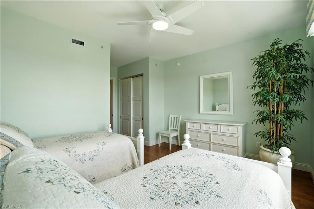 265 Indies Way, Unit 1605 Naples, FL 34110 - Photo 30 of 49 a bedroom with a bed and a potted plant