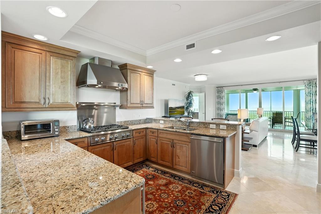 265 Indies Way, Unit 1605 Naples, FL 34110 - Photo 3 of 49 a kitchen with stainless steel appliances granite countertop a sink stove and refrigerator