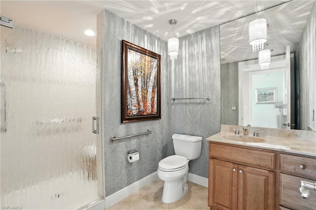 265 Indies Way, Unit 1605 Naples, FL 34110 - Photo 31 of 49 a bathroom with a granite countertop sink toilet and shower