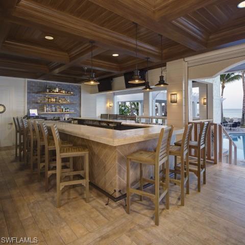 265 Indies Way, Unit 1605 Naples, FL 34110 - Photo 48 of 49 a dining table with chairs and kitchen view