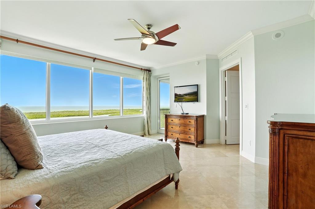 265 Indies Way, Unit 1605 Naples, FL 34110 - Photo 6 of 49 a bed room with a bed and a television