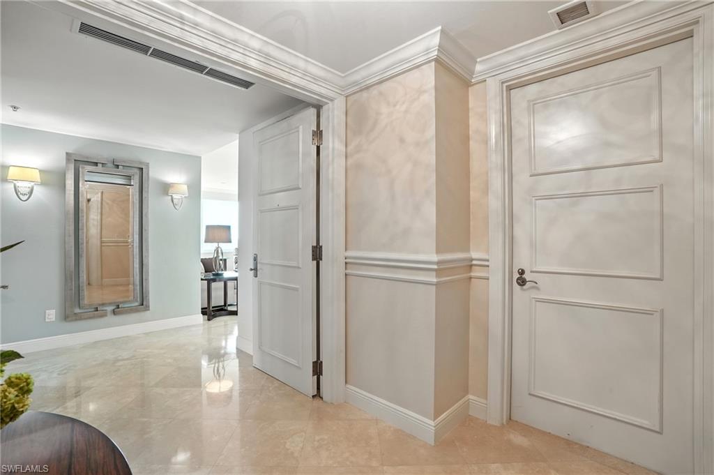 265 Indies Way, Unit 1605 Naples, FL 34110 - Photo 7 of 49 a view of a livingroom with wooden floor and a cabinet door