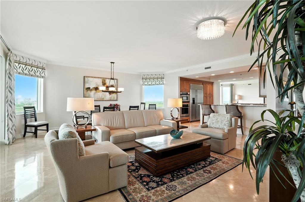 265 Indies Way, Unit 1605 Naples, FL 34110 - Photo 10 of 49 a living room with furniture a chandelier and a rug