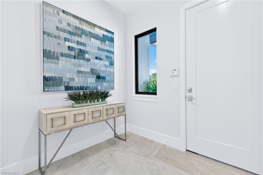 16732 Lucarno Way Naples, FL 34110 - Photo 29 of 50 Elegant modern entryway from garage space