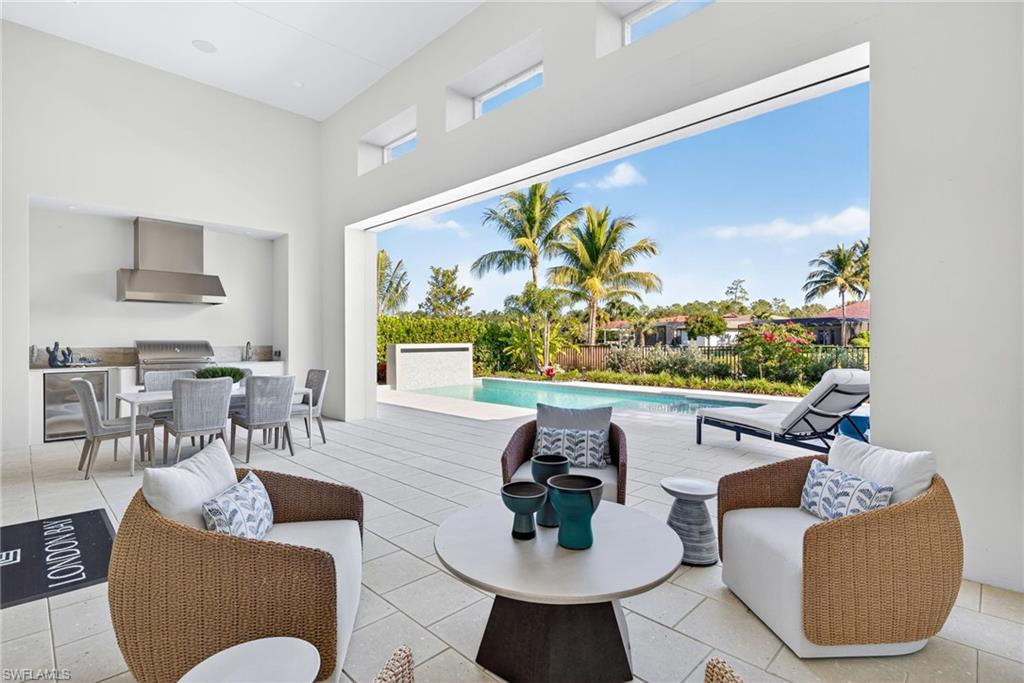 16732 Lucarno Way Naples, FL 34110 - Photo 30 of 50 Large outdoor covered lanai and outdoor kitchen area