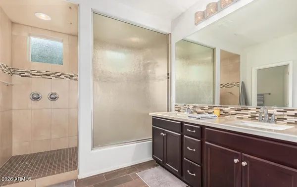 a bathroom with a sink double vanity and a mirror