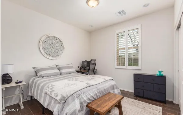 a bedroom with a bed and a closet with window