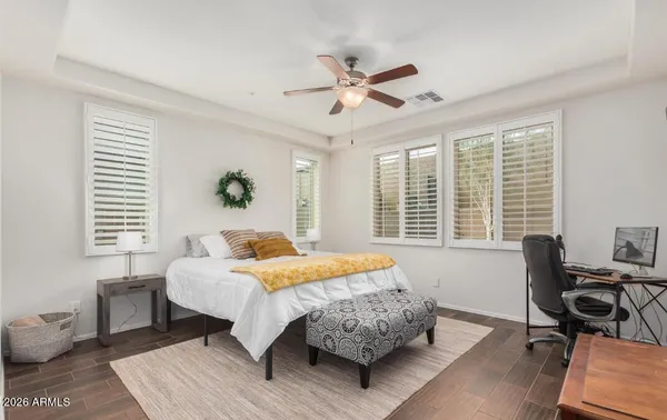 a bedroom with a bed window and a table