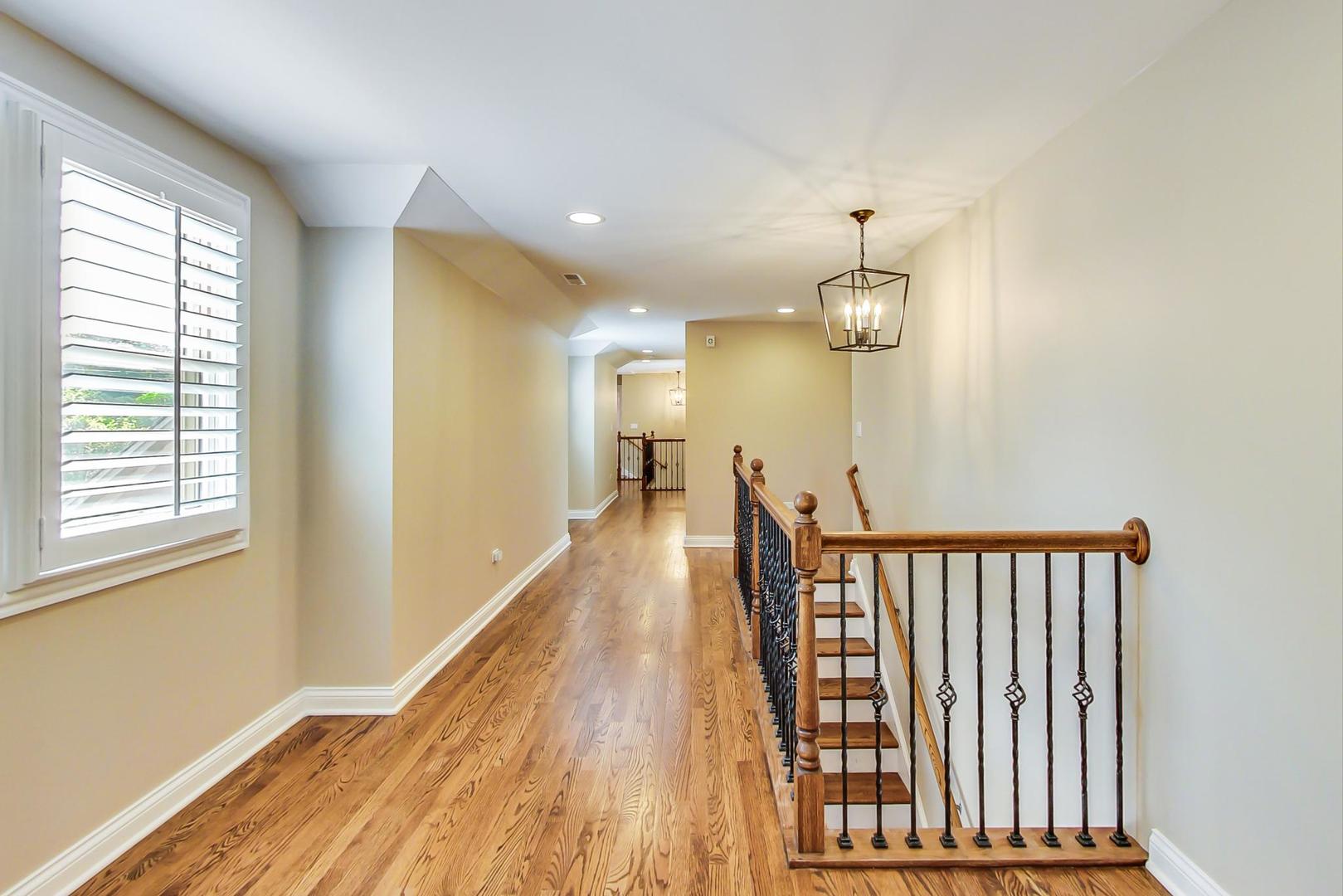 450 Voltz Road Northbrook, IL 60062 - Photo 22 of 47 a view of a hallway with wooden floor and staircase