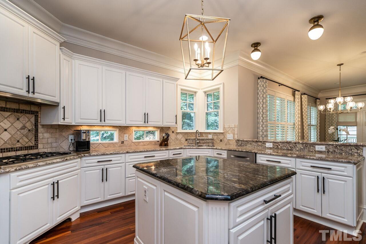 1715 Nottingham Road Raleigh, NC 27607 - Photo 11 of 35 a kitchen with granite countertop a sink a counter space appliances and cabinets