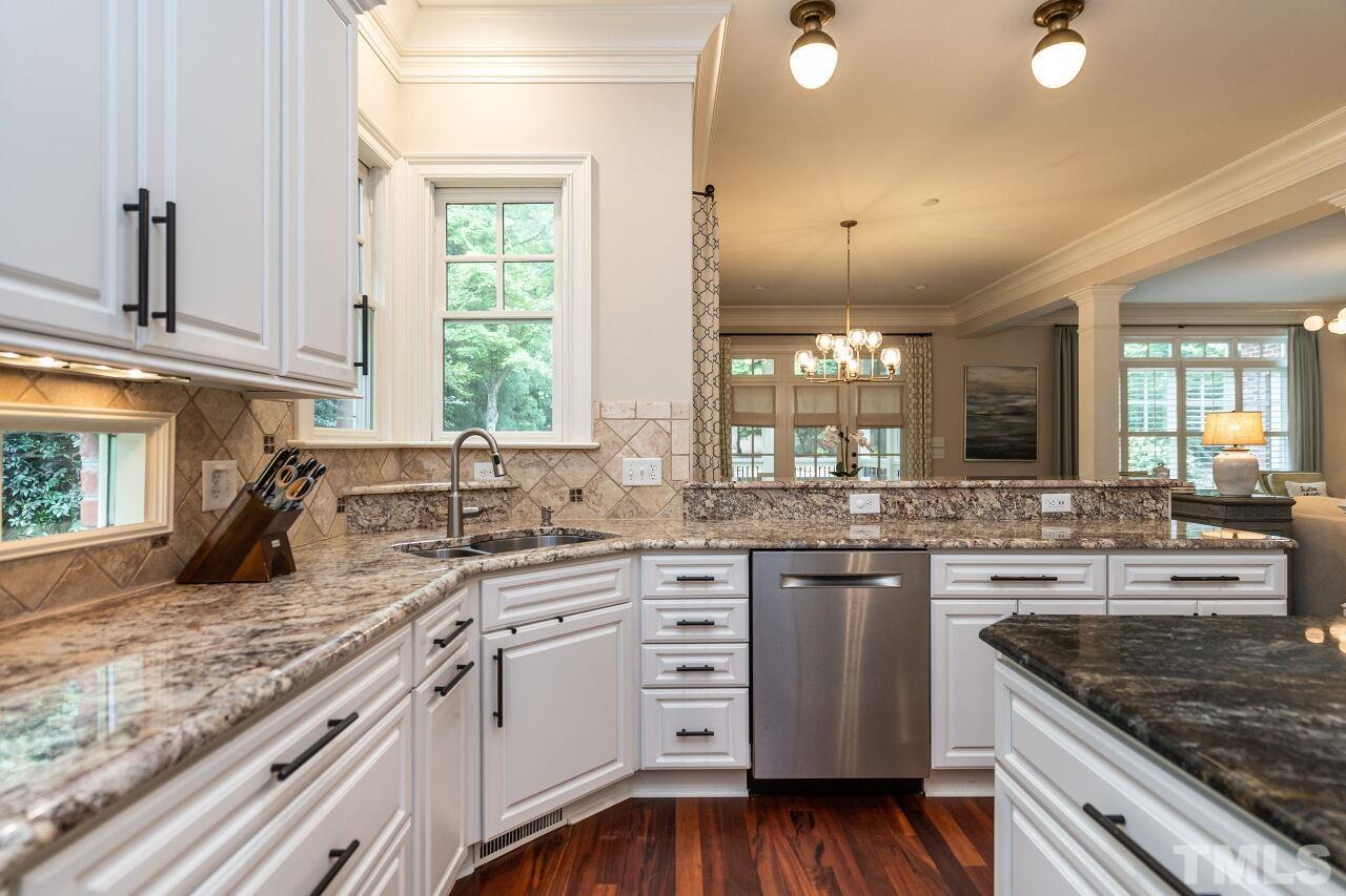 1715 Nottingham Road Raleigh, NC 27607 - Photo 12 of 35 a kitchen with stainless steel appliances granite countertop a sink stove and cabinets