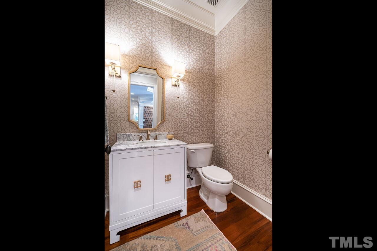 1715 Nottingham Road Raleigh, NC 27607 - Photo 15 of 35 a bathroom with a sink toilet a mirror and vanity
