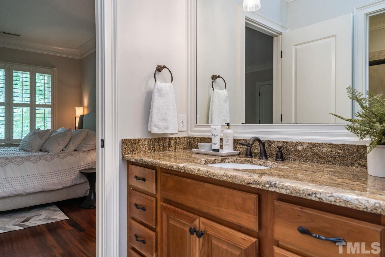1715 Nottingham Road Raleigh, NC 27607 - Photo 24 of 35 a en suite bathroom with a granite countertop sink and a mirror