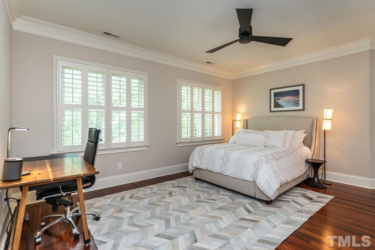 1715 Nottingham Road Raleigh, NC 27607 - Photo 27 of 35 a bedroom with a bed and a table in it