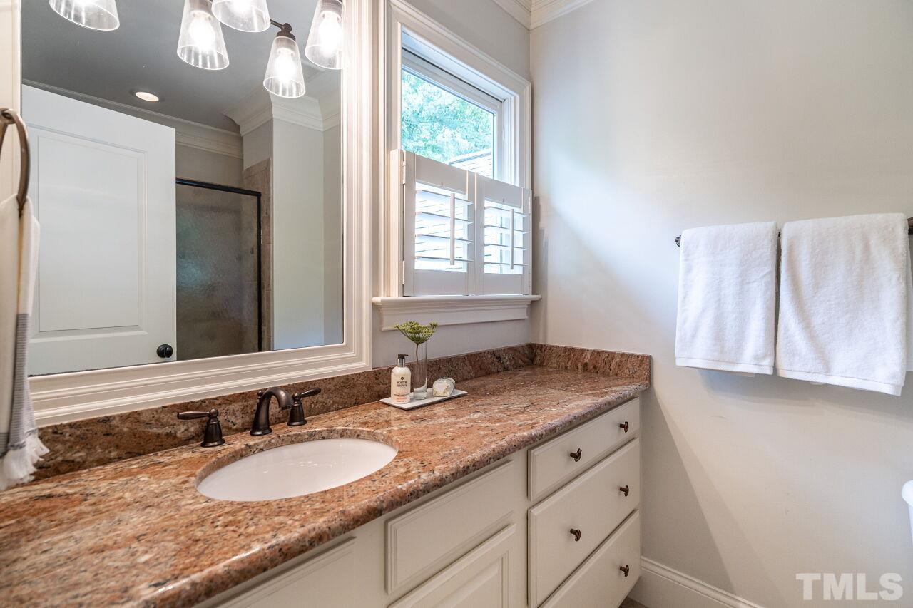 1715 Nottingham Road Raleigh, NC 27607 - Photo 28 of 35 a bathroom with a granite countertop sink and a mirror