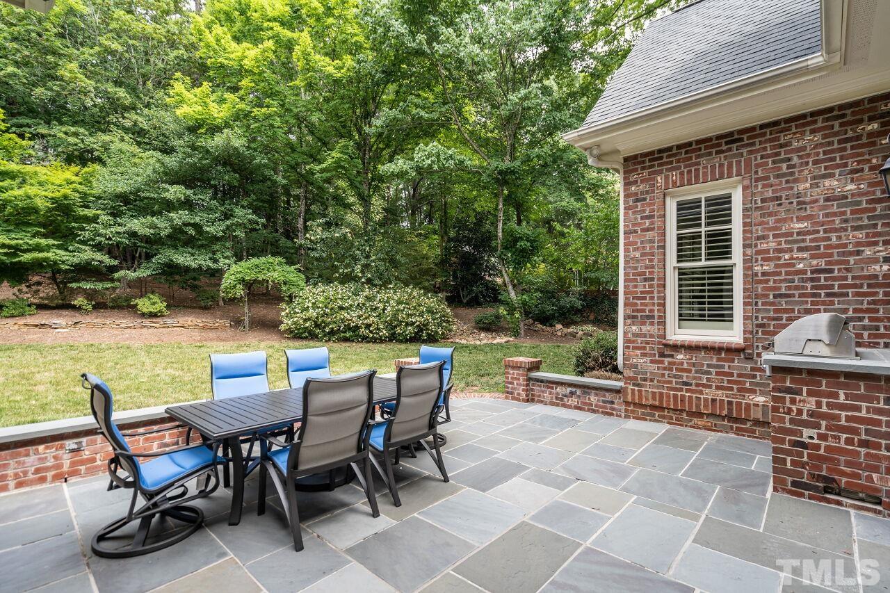 1715 Nottingham Road Raleigh, NC 27607 - Photo 32 of 35 a view of a patio with a dining table and chairs with wooden floor