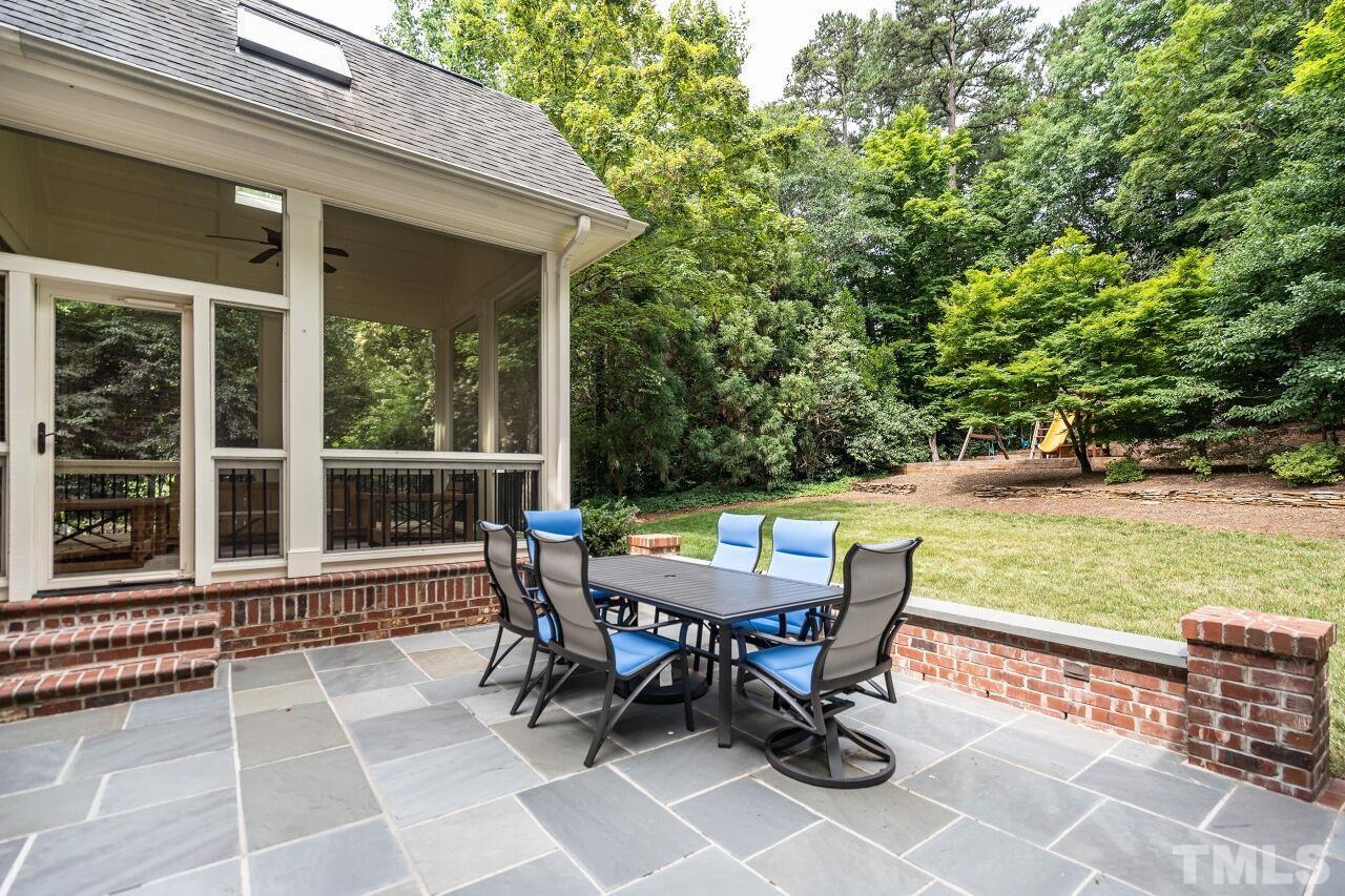 1715 Nottingham Road Raleigh, NC 27607 - Photo 33 of 35 a view of a patio with a dining table and chairs with wooden floor and fence