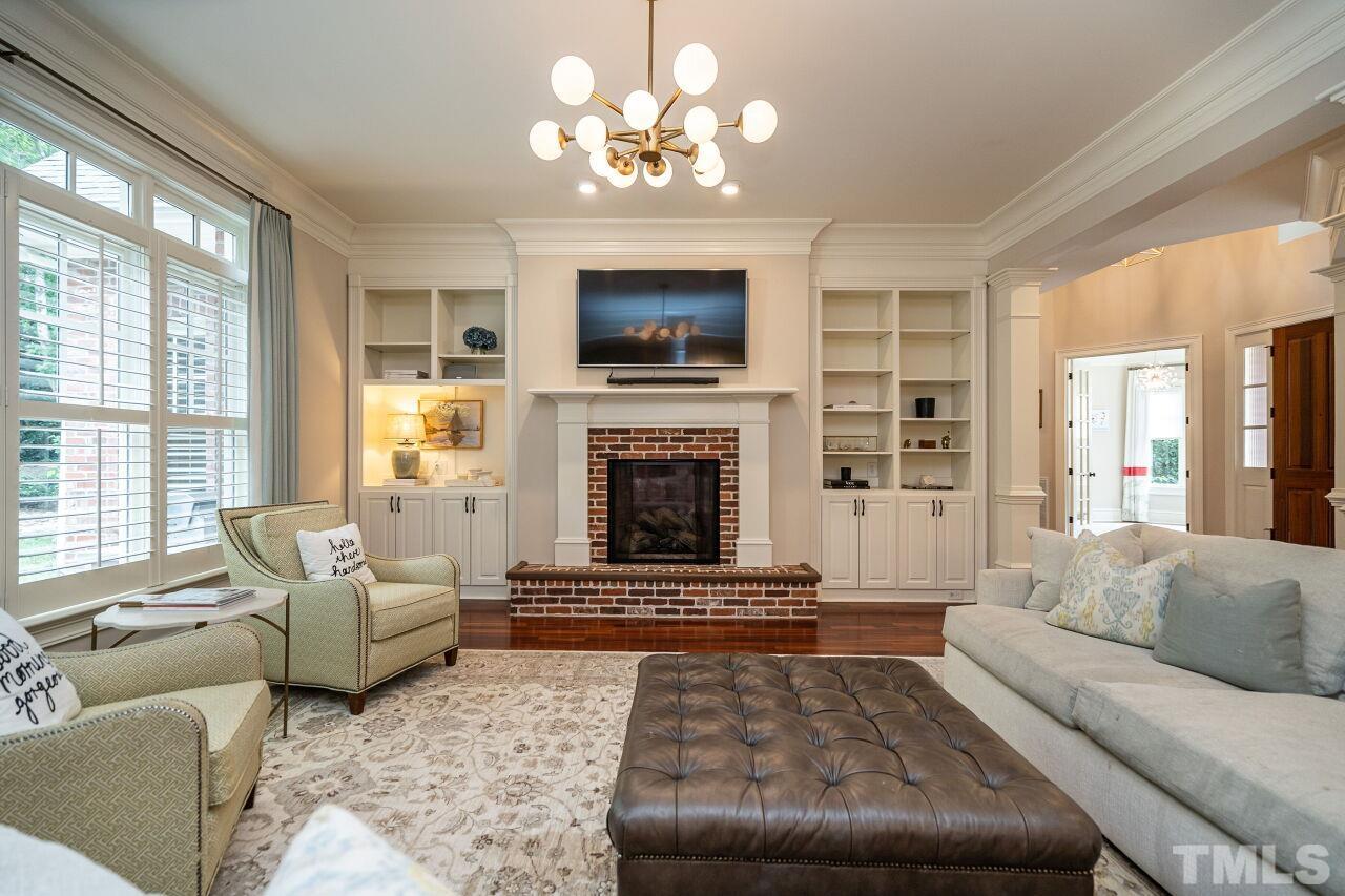 1715 Nottingham Road Raleigh, NC 27607 - Photo 6 of 35 a living room with furniture a flat screen tv and a fireplace