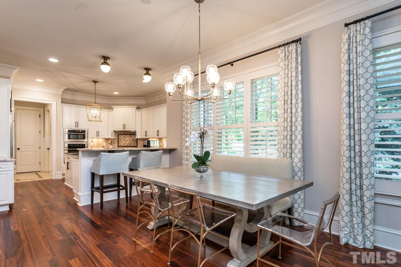 1715 Nottingham Road Raleigh, NC 27607 - Photo 8 of 35 a view of a dining room and livingroom with furniture wooden floor a chandelier