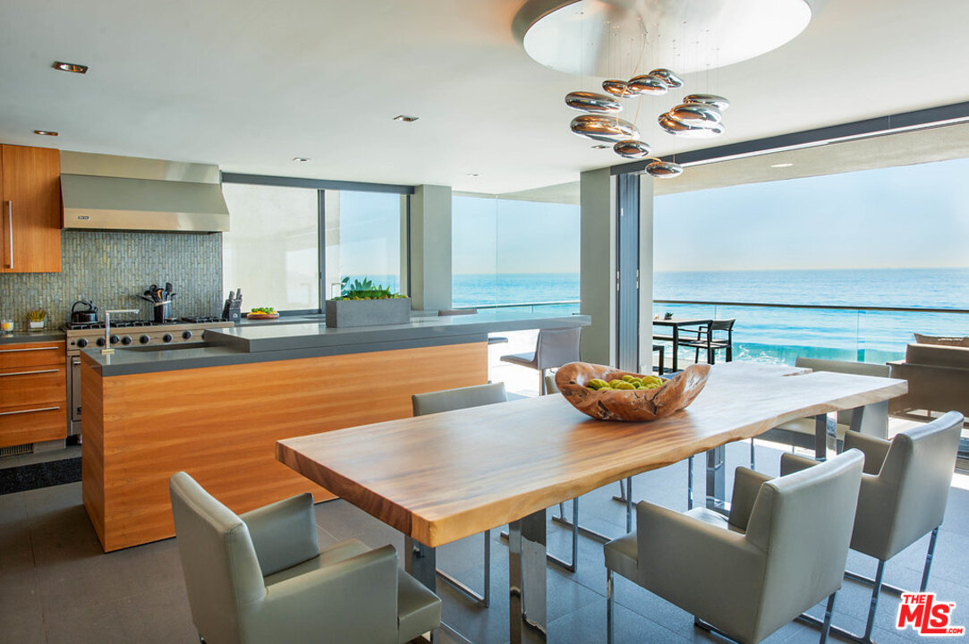 24450 Malibu Road Malibu, CA 90265 - Photo 12 of 34 a view of a dining room with furniture a chandelier and wooden floor