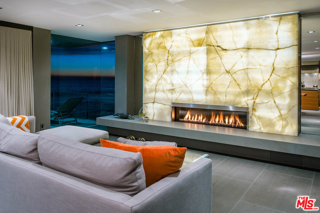 24450 Malibu Road Malibu, CA 90265 - Photo 23 of 34 a living room with a couch and a fireplace