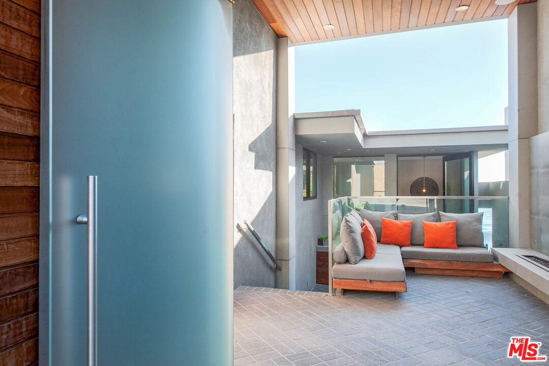 24450 Malibu Road Malibu, CA 90265 - Photo 4 of 34 an outdoor living room with a couch and wooden floor